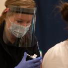 emt administers vaccine shot